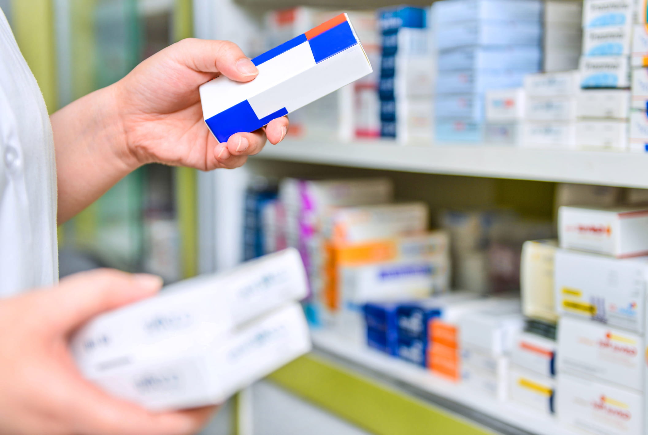 Pharmacist stocking over-the-counter medicines