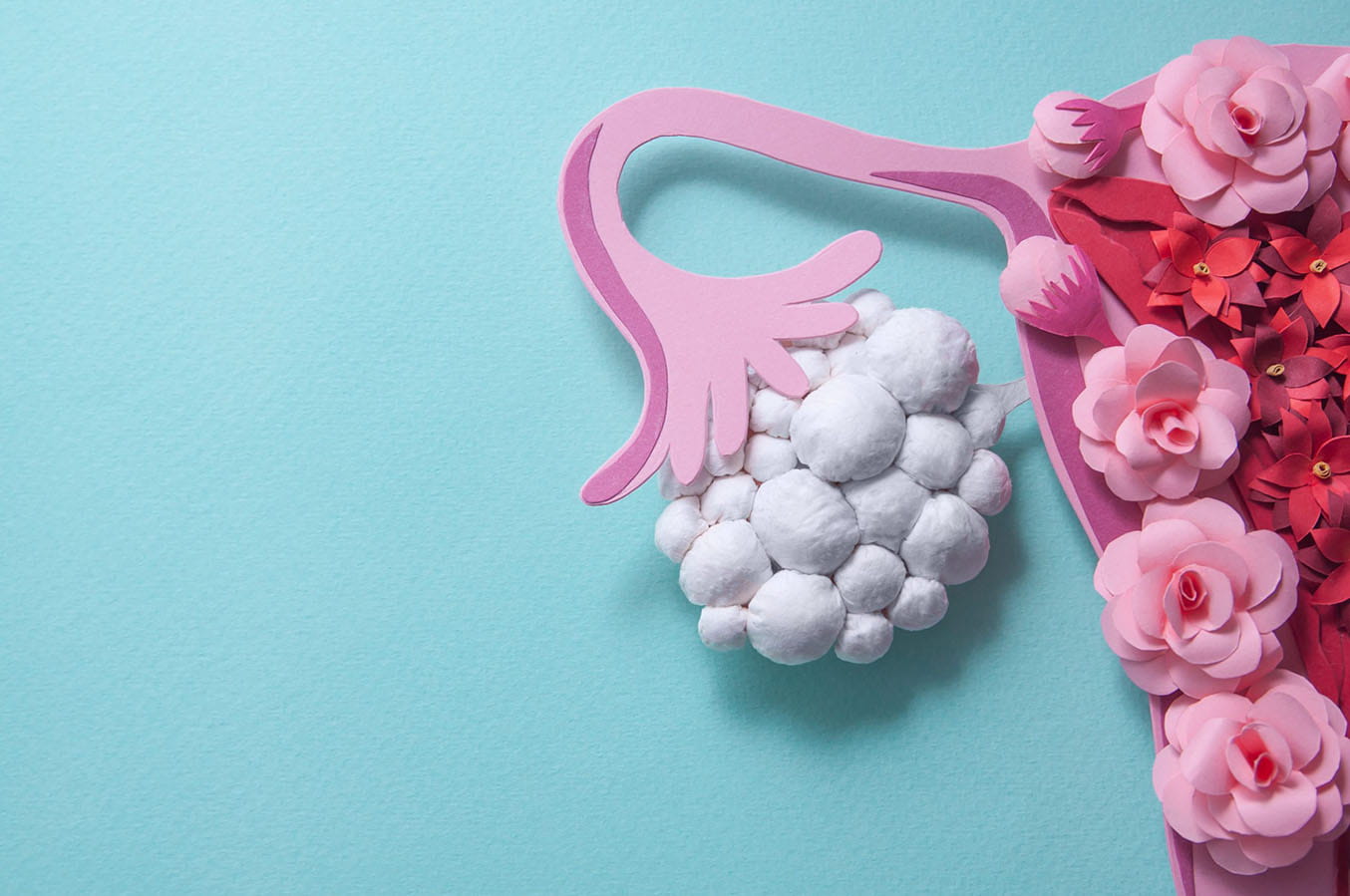 A pink cartoon uterus made out of flowers