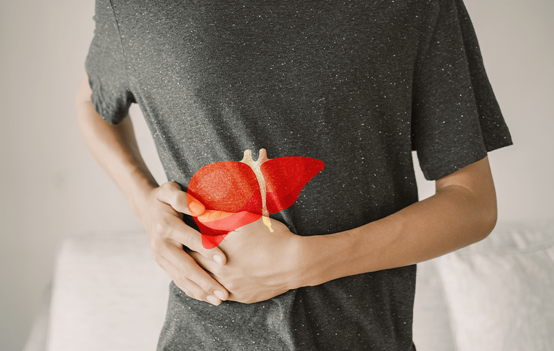 A man clutches his side, where there is an illustration of a liver.