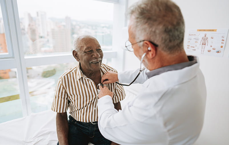 Portrait of a doctor listening to a patient's heartbeat
