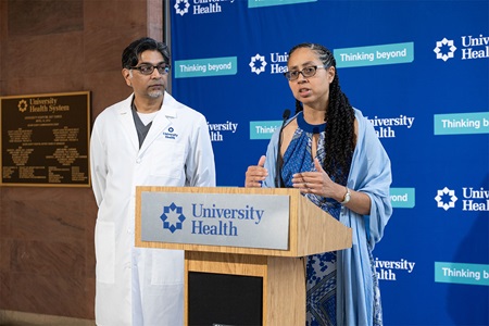 Commissioner Clay-Flores at a press conference with Dr. Patel.