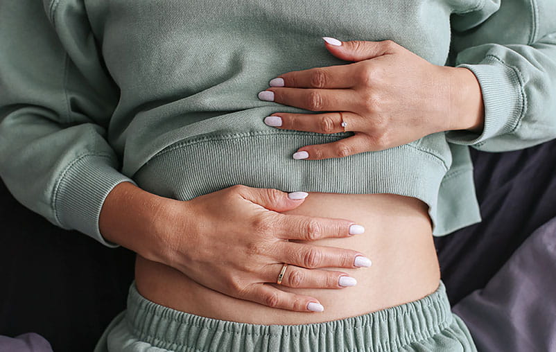 Woman holding stomach. 