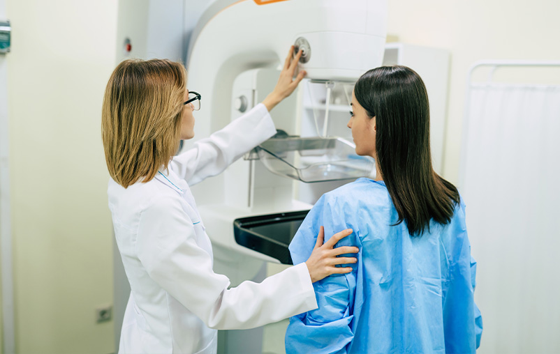 A woman gets a mammogram.