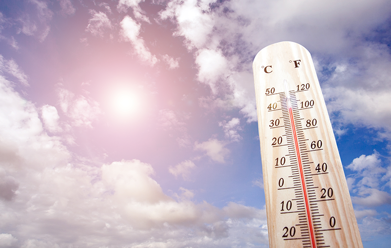 Thermometer against a backdrop of a sunny sky