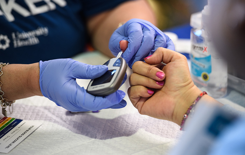 A woman gets her blood glucose tested at World Diabetes Day at Texas Diabetes Institute.