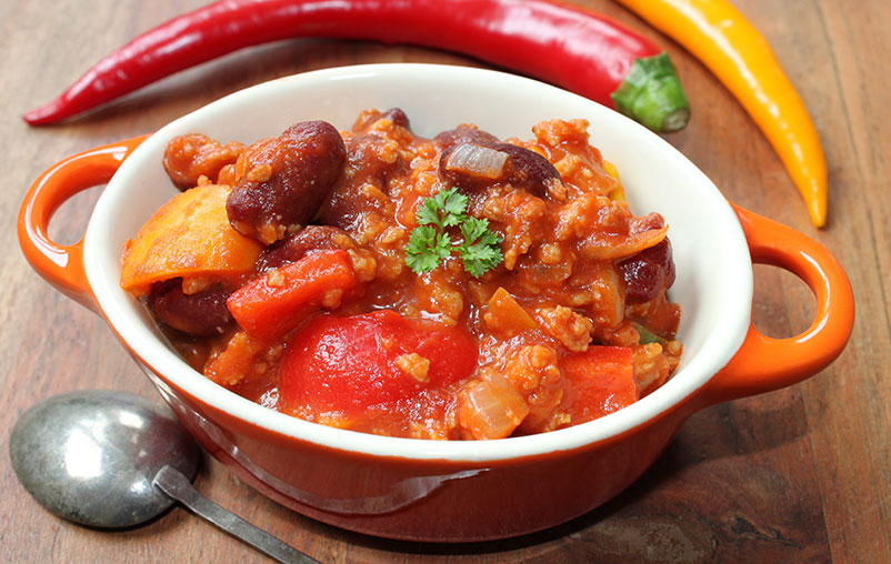 Vegetarian chili in a red bowl.