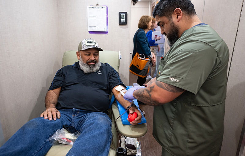 Blood donor inside the University Health Mobile Blood Donation Unit, powered by University Health Foundation and Toyota Texas.